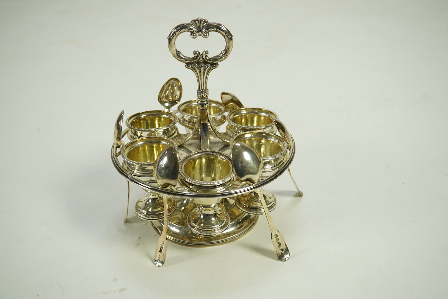 A George III silver egg cruet stand, with six egg cups and six spoons (one not matching), by Solomon Royes & John East Dix